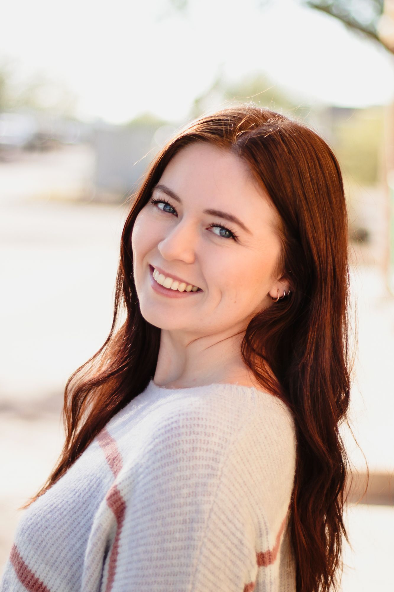 An adult woman smiles over her shoulder after visiting our orthodontist in Florence, AZ/
